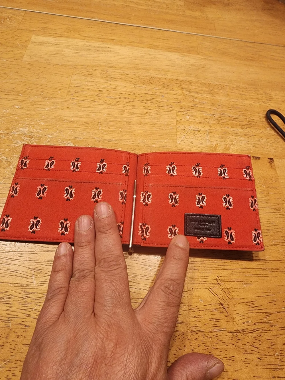 Saint Laurent wallet features a distinctive paisley bandana print on interior